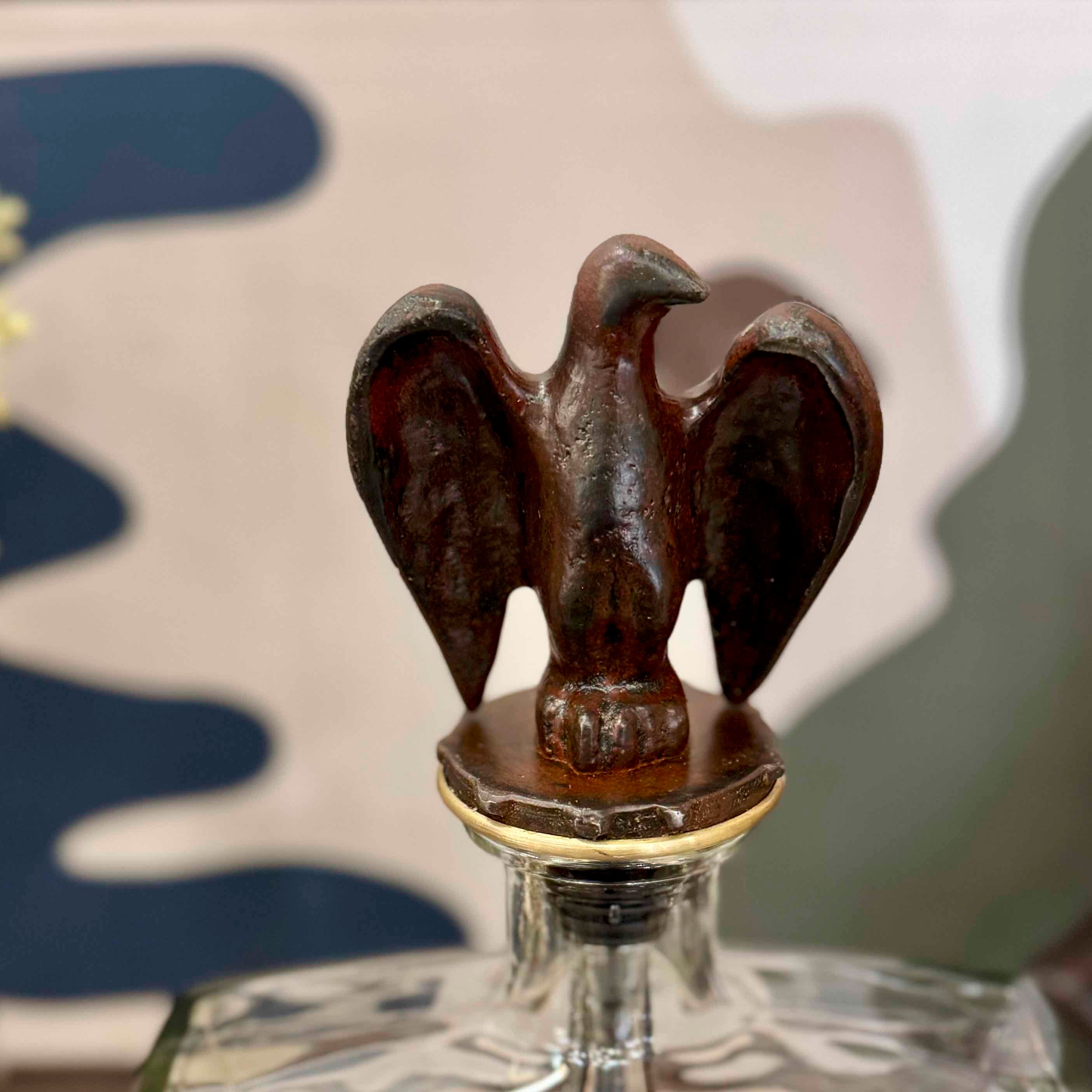 Decorative bottle stopper with an eagle design on a glass bottle.