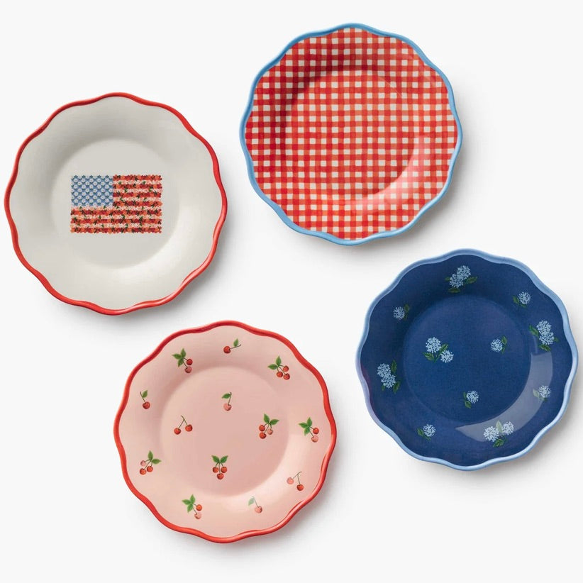 Four decorative plates with different patterns on a white background