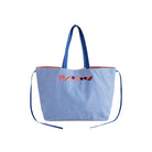 Blue striped tote bag with decorative elements on a white background