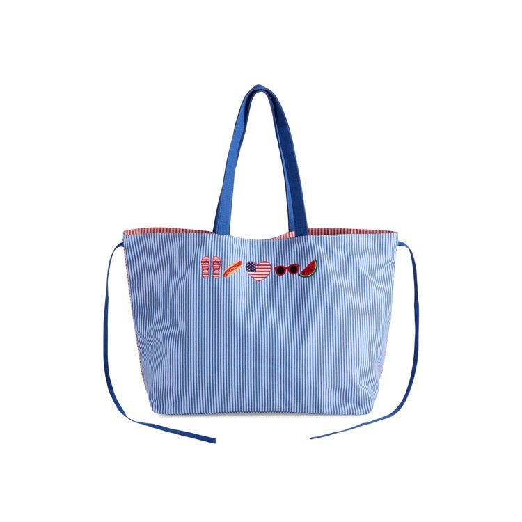 Blue striped tote bag with decorative elements on a white background