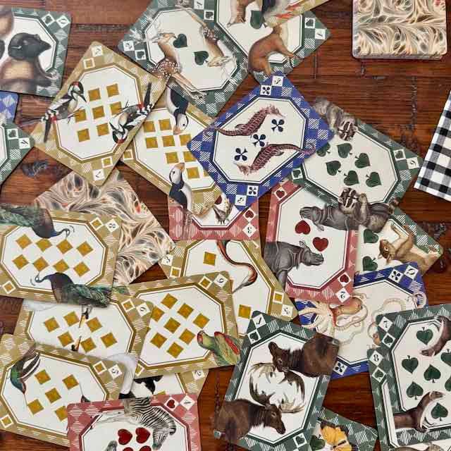 Collection of decorative tiles with animal illustrations on a wooden surface