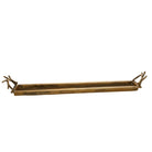 Long, narrow brass tray with decorative ends on a white background