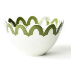 White bowl with green wavy rim on a white background