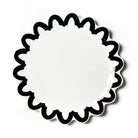 White circular object with black decorative border on a white background