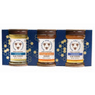 Three jars of honey from the American Bee Company in a decorative box on a white background.