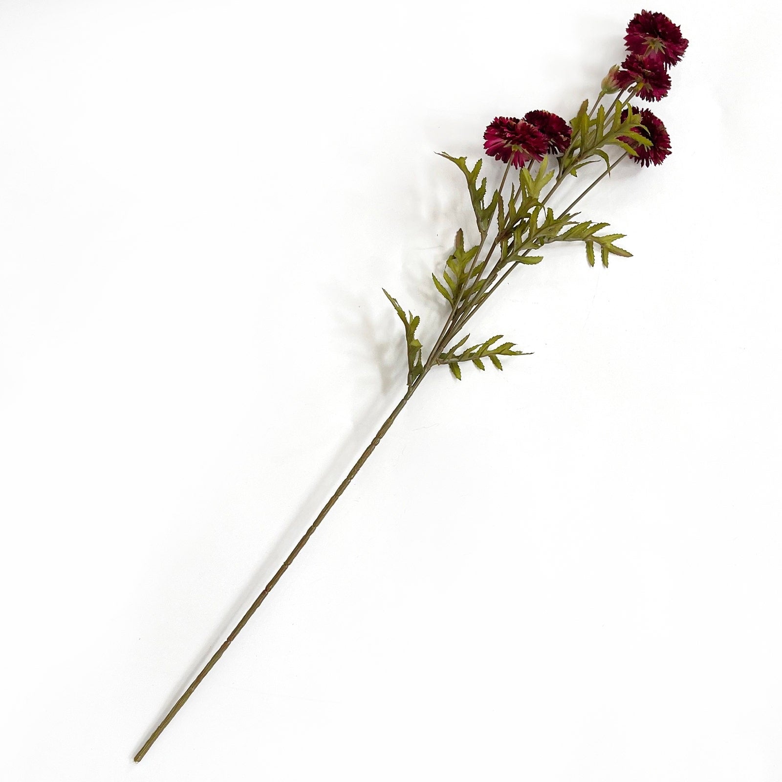 Artificial flower stem with burgundy flowers on a white background