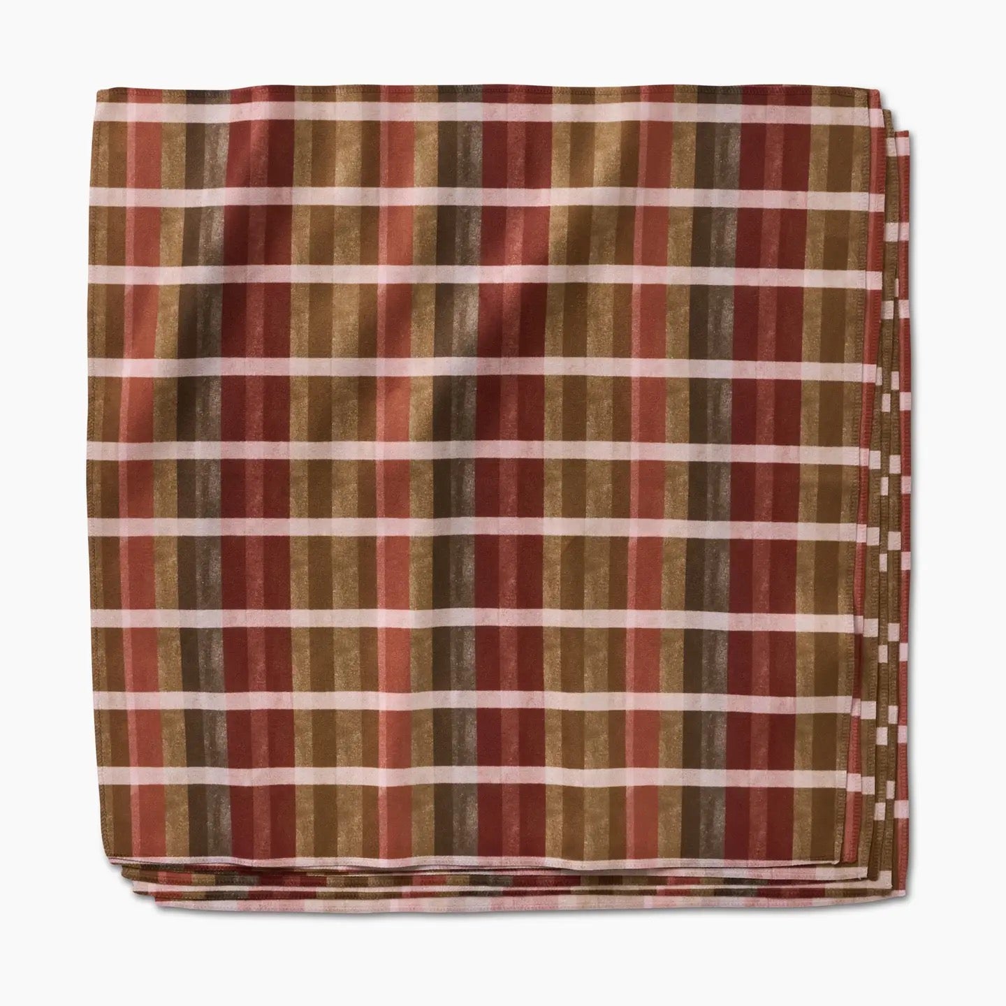 Folded fabric with a plaid pattern featuring brown, red, and beige colors on a white background.