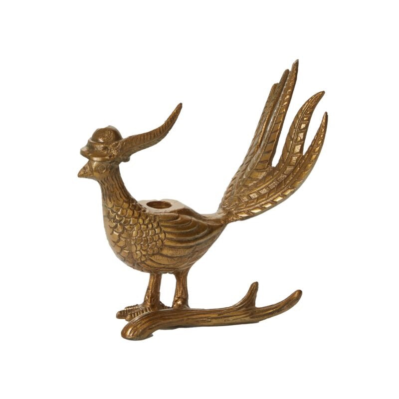 Antique gold finished metal candlestick holder in the shape of a bird perched on a branch.