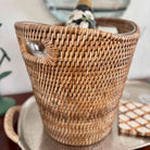Woven basket with a bottle of champagne on a table