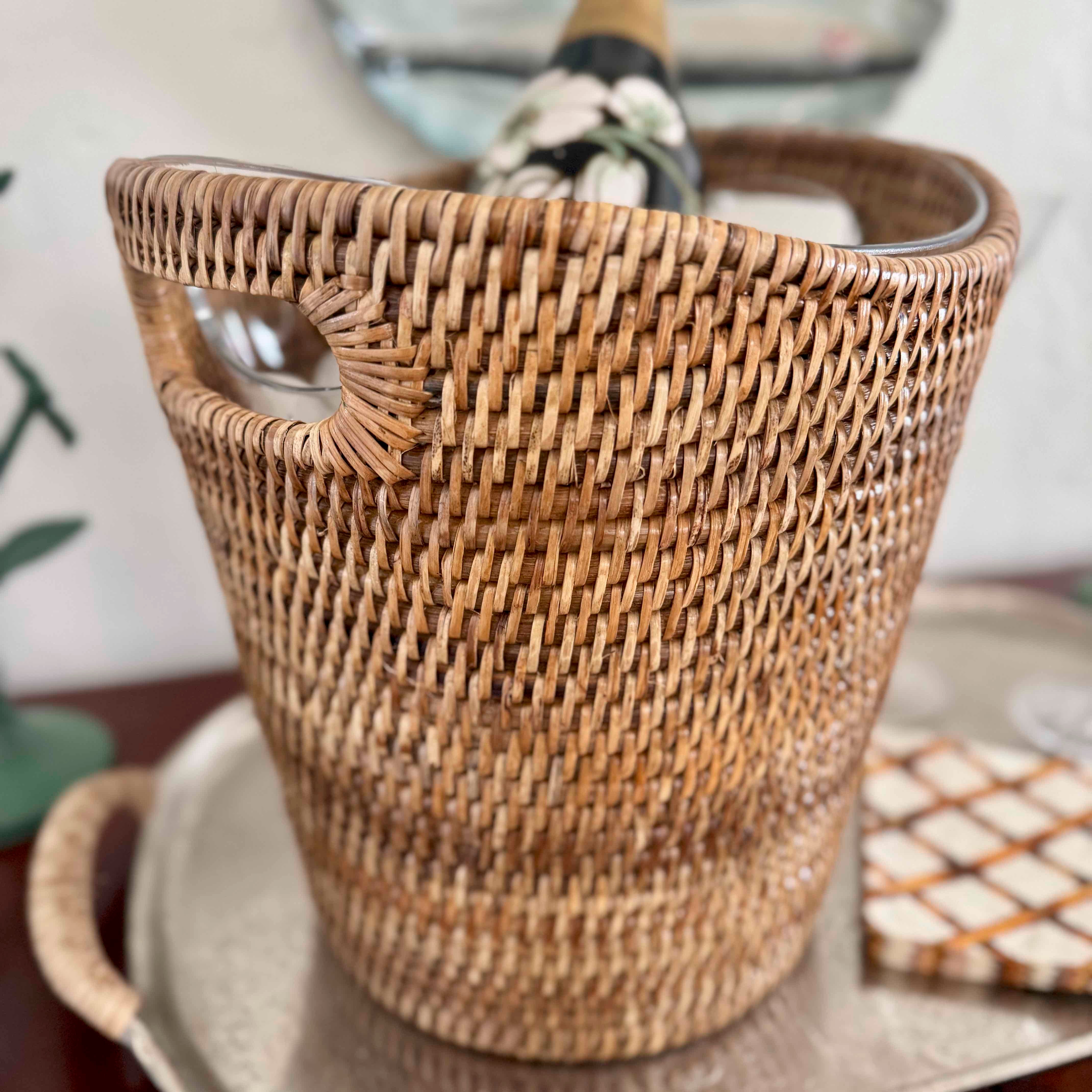 Woven basket with a bottle of champagne on a table