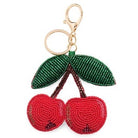 Keychain shaped like a beaded cherry with a green leaf on a white background