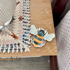 Jigsaw puzzle with a bee design on a wooden table