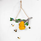 Toy with a branch, yellow bee, and small birds on a white background