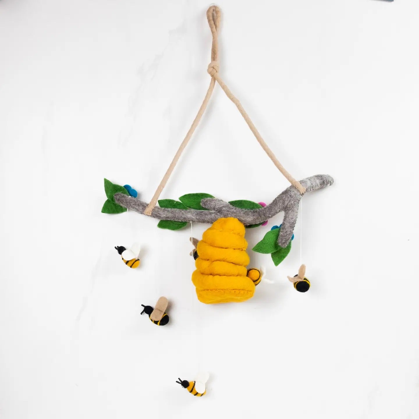 Toy with a branch, yellow bee, and small birds on a white background