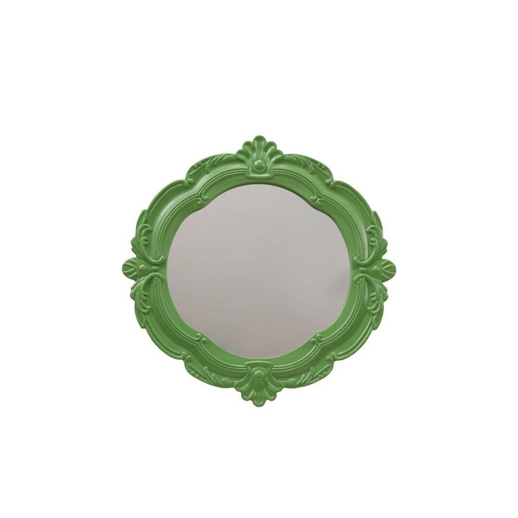 Green decorative mirror on a white background