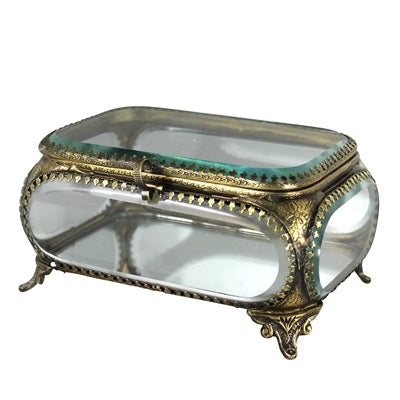 Decorative glass box with gold embellishments on a white background