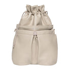 Beige drawstring bag with multiple compartments on a white background