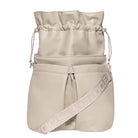 Beige drawstring bag with a strap featuring a logo on a white background