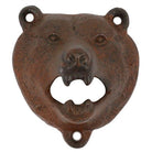 A rustic cast iron bear head bottle opener with a weathered brown and black patina, isolated on a white background.