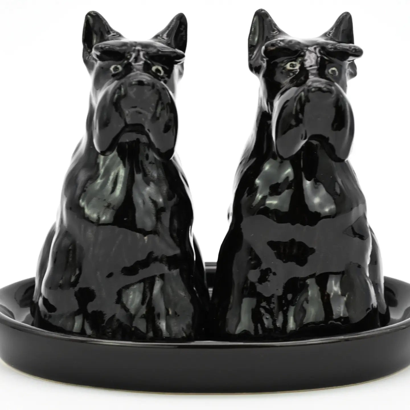 Black ceramic dog-shaped salt and pepper shakers on a matching tray.