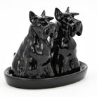 Black ceramic dog figurine on a white background