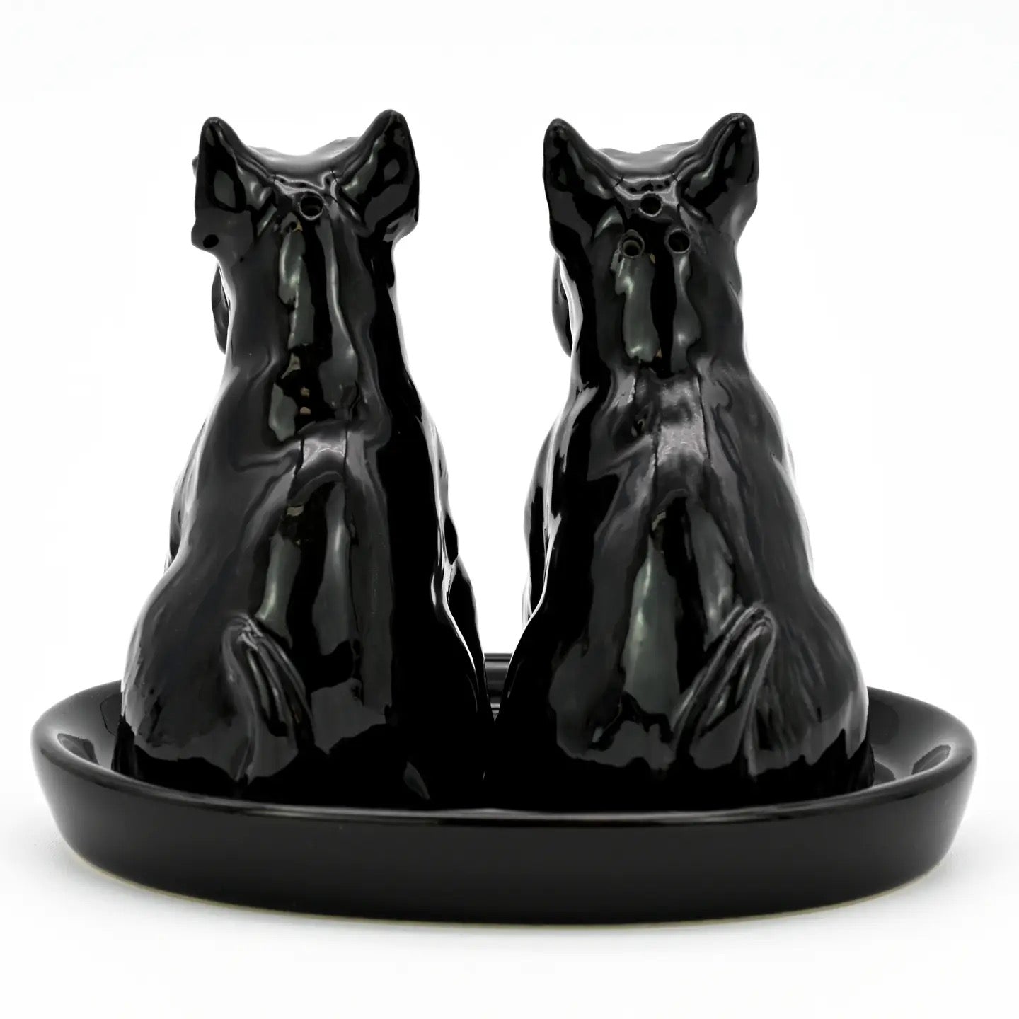 Black ceramic horse salt and pepper shakers on a matching tray.