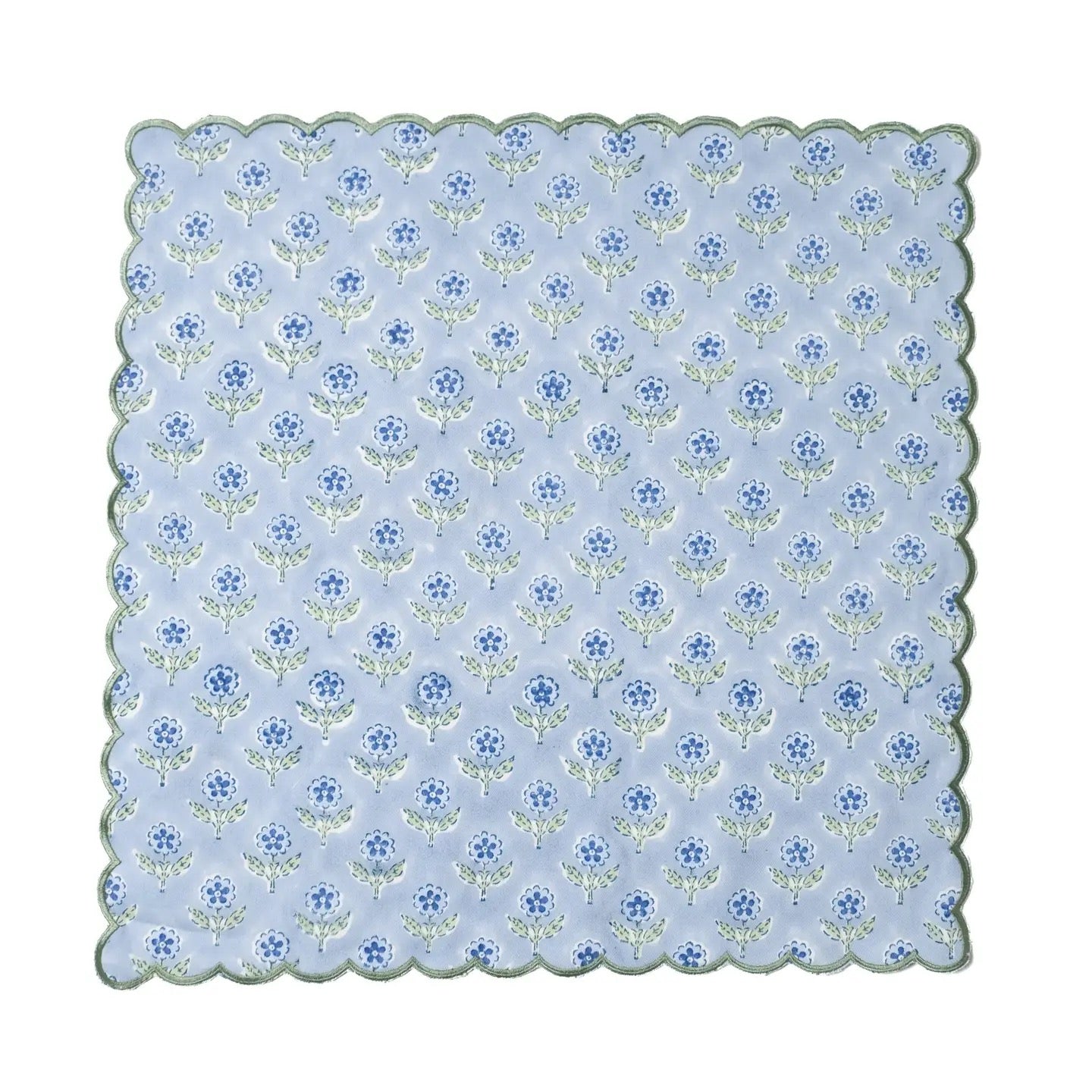 Scalloped-edged fabric swatch with blue floral pattern on a light blue background