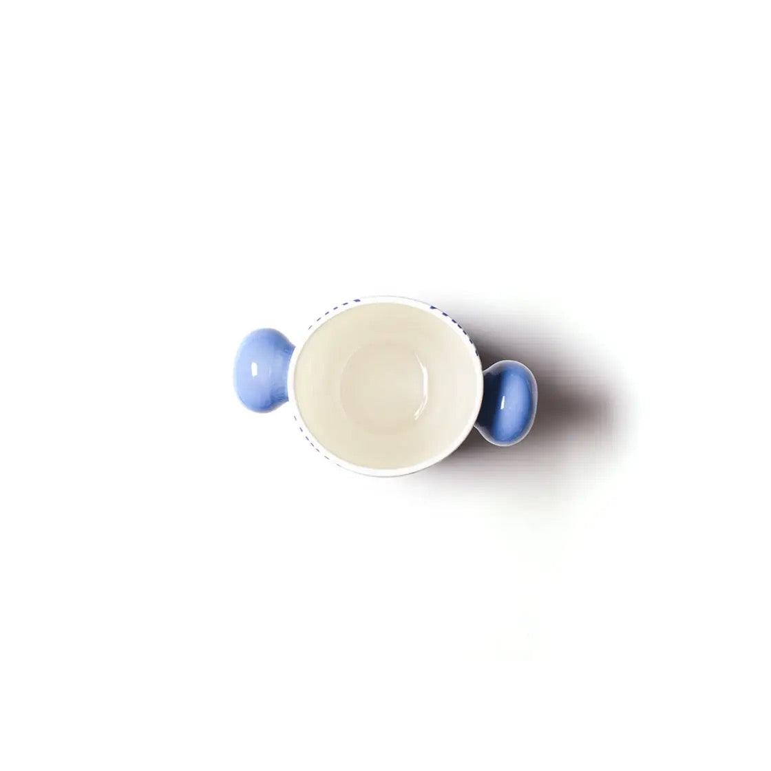 White ceramic cup with blue handles on a white background