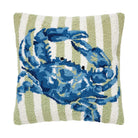 Pillow with a blue crab design on a green and white striped background