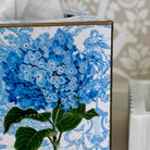 Decorative box with blue floral design on a white background