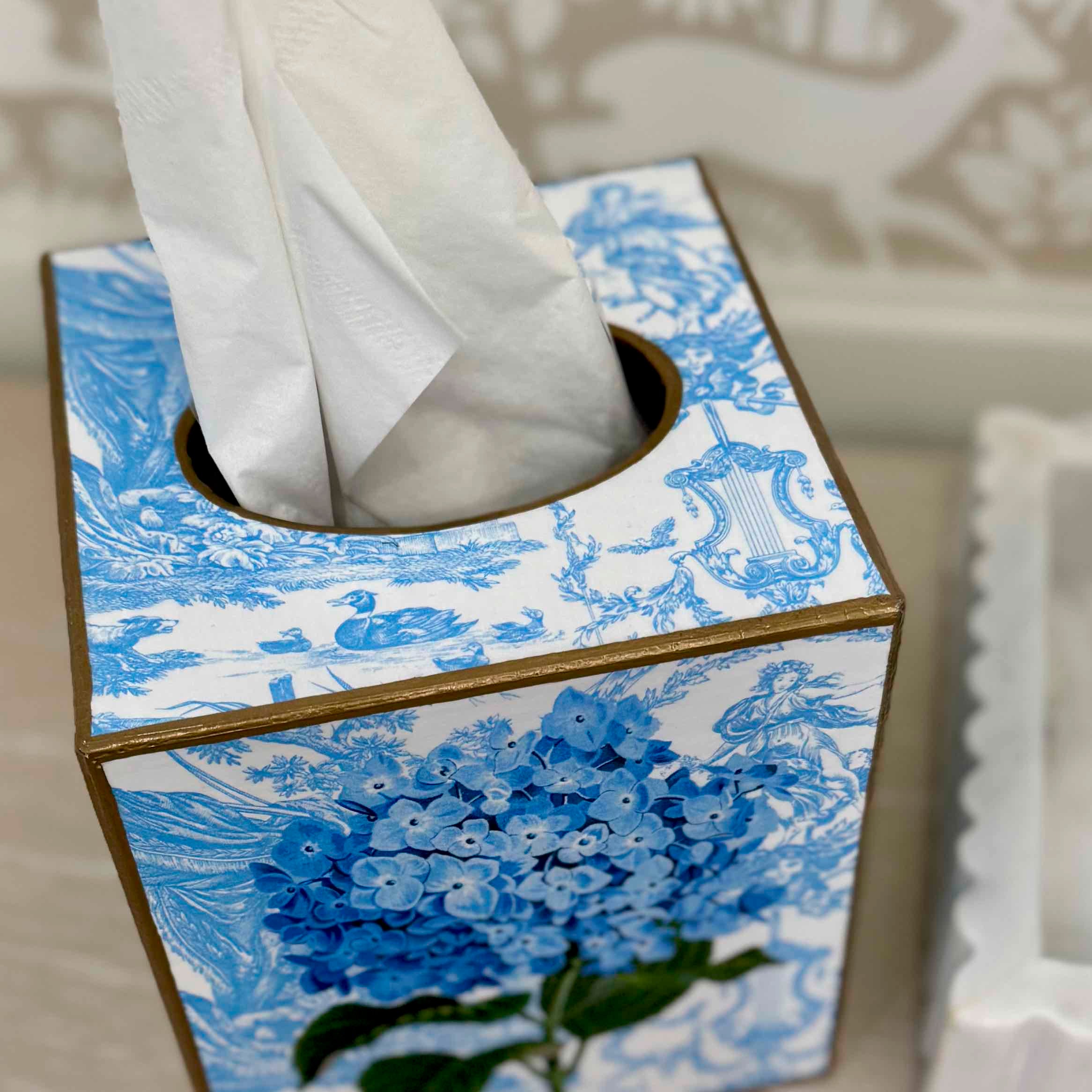 Tissue box cover with blue floral design on a white background