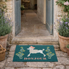Decorative doormat with a poodle design and 'Bonjour' text on a stone path.