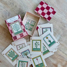 Playing cards with botanical designs on a wooden surface