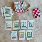 Set of playing cards with botanical designs on a wooden surface