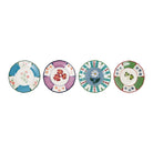 Four decorative ceramic plates with floral and botanical patterns, arranged in a row against a plain white background.