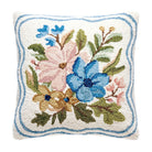 A square decorative throw pillow with a textured, looped floral design. The pillow features a cream-colored background with a blue border and a central floral motif in blue, pink, green, and yellow.