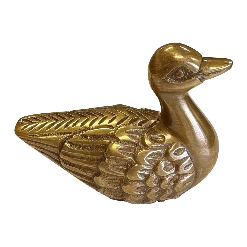 Gold duck-shaped decorative item on a white background