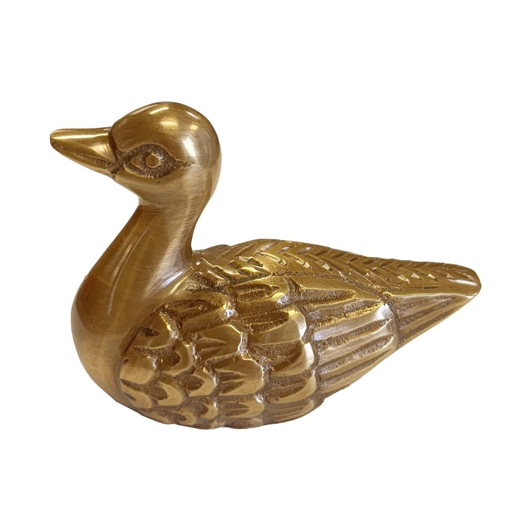 Gold duck-shaped object on a white background