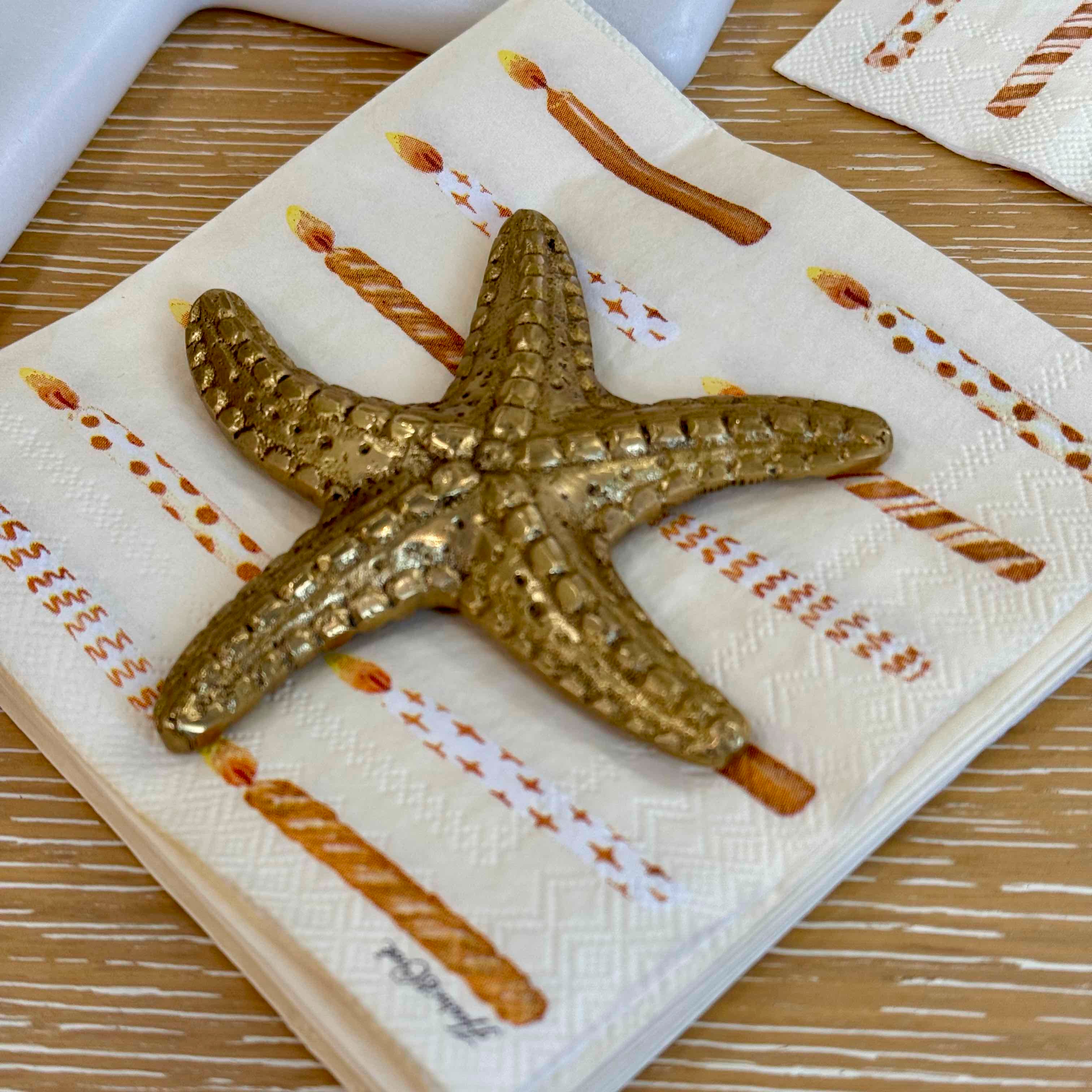 Decorative starfish on a patterned napkin with a wooden surface background