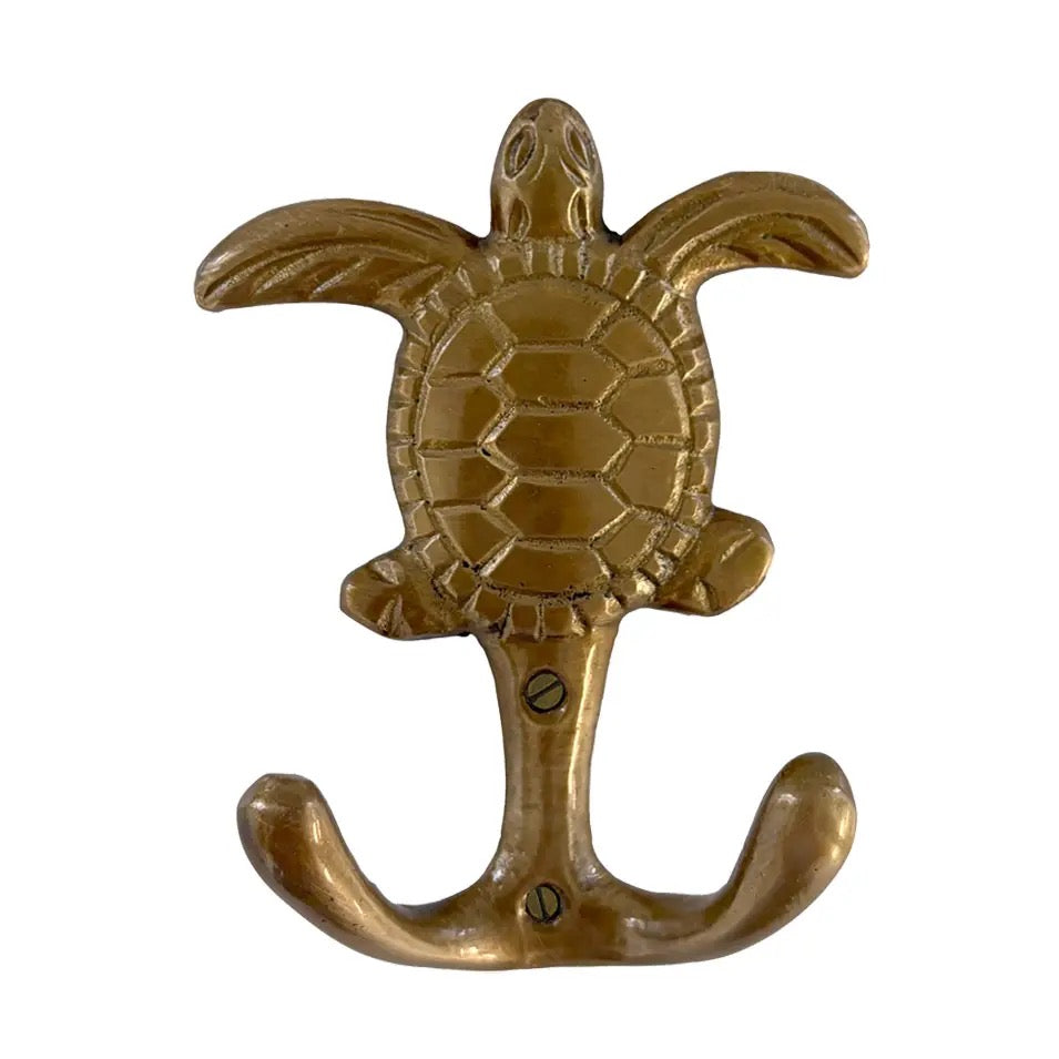 A brass turtle-shaped wall hook with an anchor base, shown against a plain white background.