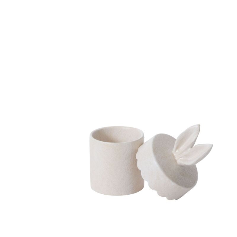 White ceramic cup with a matching rabbit-shaped container on a white background