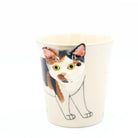 Mug with a calico cat design on a white background
