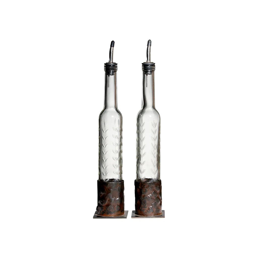 Two glass bottles with metal nozzles on a white background