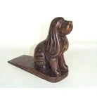 Bronze dog-shaped door stopper on a white background