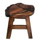 A rustic wooden stool with a carved seat featuring a horse design, finished in dark brown wood with black painted accents.