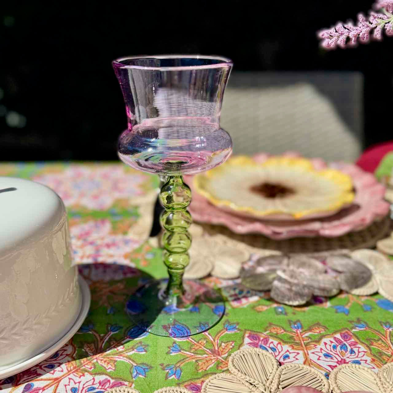 Decorative glass on a colorful tablecloth with floral patterns