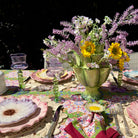 Decorative table setting with flowers and colorful tablecloth