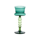Green glass goblet with a textured stem on a white background