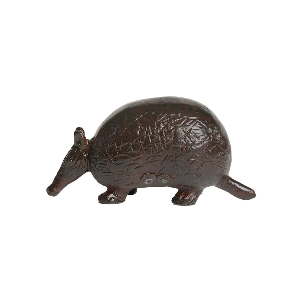 Bronze armadillo figurine on a white background