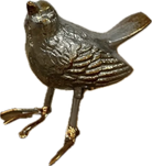 Metallic bird figurine on a white background